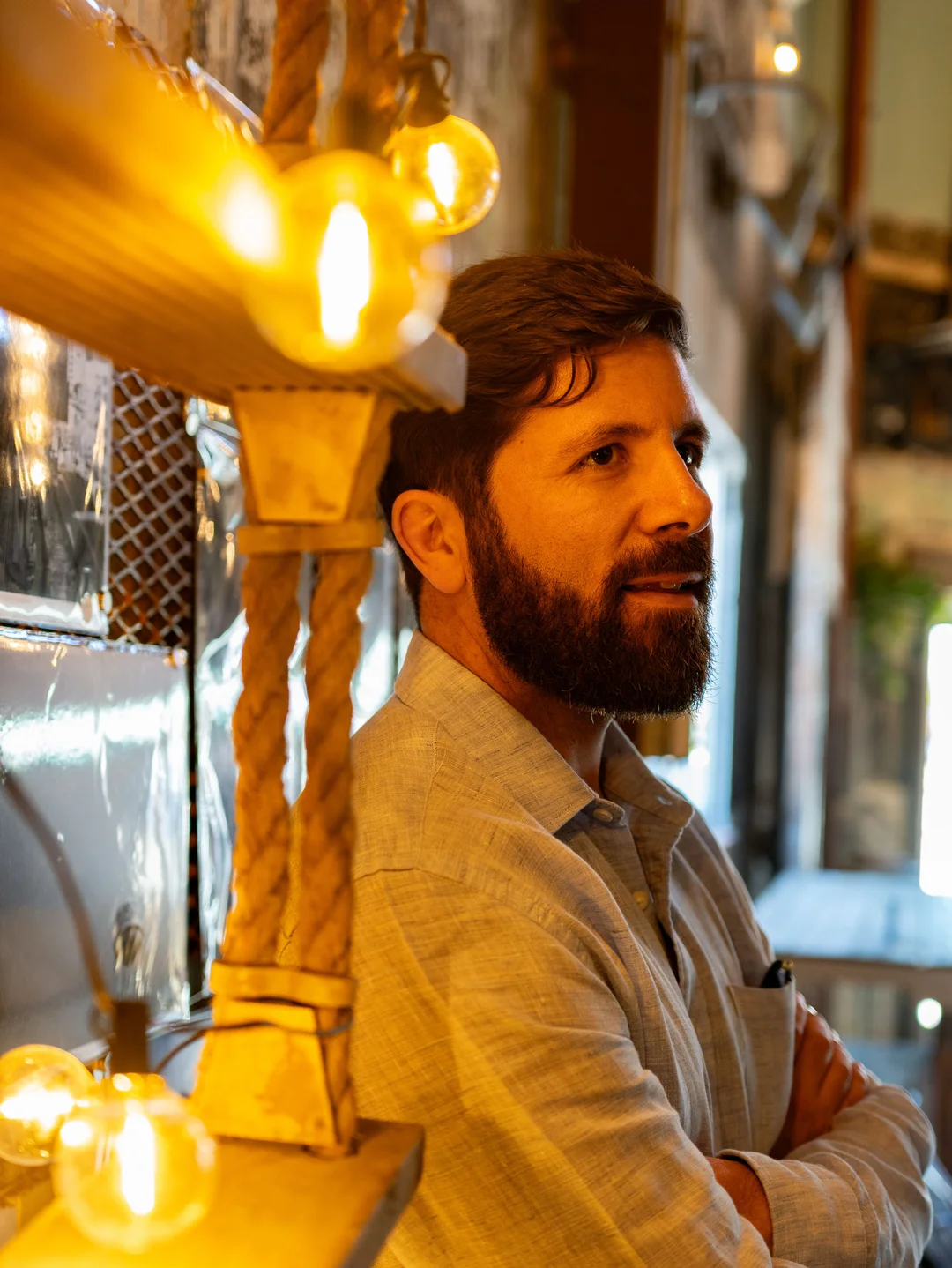 Ringba User Stories - Bill Somerville Leaning Against Wall Near Lighbulbs